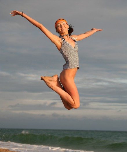 Very skinny and natty teen jumping and flying naked on the shore